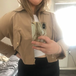 Jacka - En jättefin vår jacka från SHEIN i en beige färg med guldiga detaljer. Köparen står för frakten!