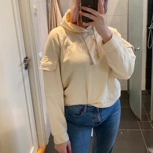 Hoodie - Säljer denna hoodie i strl M från gina tricot. Färgen är lite beige/gul och det är fickor på båda armarna. Köpt för ca 300 kr och inte använd så mycket, säljer för 99 kr köparen står för frakt