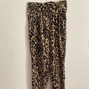 Leopardmönstrade vintage-byxor - Pösiga byxor i skönt material, hög och smal midja. Dragkedja på sidan. Lite trasiga på insidan vaderna, kan skicka bild, men går att laga för den händiga!