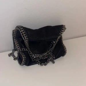 Stella Mccartney liknande väska - Lägger ut igen för köparen ångrade sig. Jättefin skimrande svart väska som liknar Stella Mccartney😍 Den är i ett bra skick och passar till allt! Pris kan diskuteras vid snabb affär💗BUDA INTE OM DU INTE ÄR HELT SÄKER⚠️