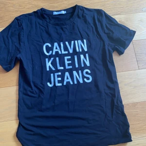 Calvin Klein t-shirt storlek 12 år - Svart t-shirt med vit text. Köpt för 1 år sen men bara användt ett par enstaka gånger.