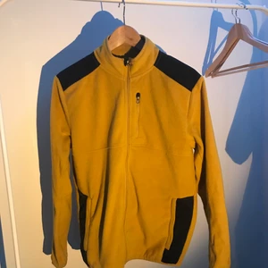 Fleecejacka - Gul fleecejacka från Dressmann i small. Fickor med dragkedja samt en ficka med dragkedja på vänstra bröst. Håller värmen