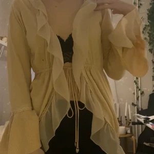 kofta med volanger - en beige kofta med volanger och knytning fram och på ärmarna! ingen angiven storlek men passar mig som oftast bär S-M i toppar, skulle passa XXS-M beroende på passformen. Kontakta om du är intresserad eller har övriga frågor!❤️