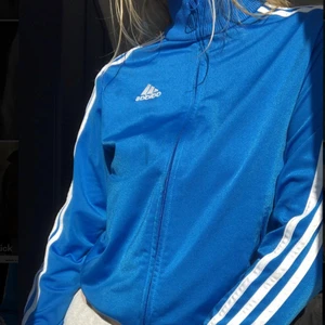 Adidas - Säljer denna vintage adidas tröjan i den perfekta blåa färgen. Denna modell säljs inte längre. Super fint skick och sitter dö snyggt till typ ett par lågmidjade jeans. Passar en XXS-S, kan skicka fler bilder om så önskas💙⚡️