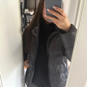 Mörkgrå dunjacka från Polo Ralph Lauren - Säljer en mörkgrå dunjacka från Polo Ralph Lauren med hög krage och dragkedja framtill. Jackan har två sidofickor med dragkedja. Lite använd förra vintern men fint skick!