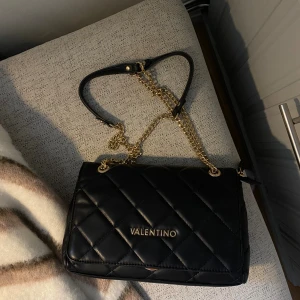 Svart väska från Valentino - Snygg svart axelväska från Valentino. Köpt på Zalando och använd ett fåtal gånger💕💕pris kan diskuteras