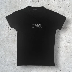 Armani T-Shirt - Säljer denna svarta T-Shirten från Emporio Armani i stl S. Tröjan är i bra skick utan några defekter förutom storlekstrycket som är lite slitet men inget man ser. Hör av er vid frågor!