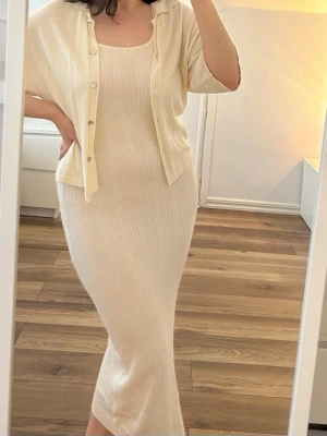 Stickad klänning - Säljer en ribbad midiklänning i ärmlös design. Klänningen är tillverkad i ett mjukt material. Perfekt för sommarens alla tillfällen! Oanvänd. 