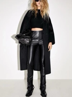 Svarta tighta skinnbyxor - Säljer ett par svarta, glansiga skinnbyxor med tight passform och hög midja. Byxorna har en stilren look och sitter som en andra hud.