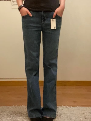 Bootcut jeans - Blå bootcut jeans från Lager157 med klassisk femficksdesign och kopparfärgade knappar. Modellen heter 90's Boot Star. Skriv om du har frågor och läs min bio innan du köper💗💗