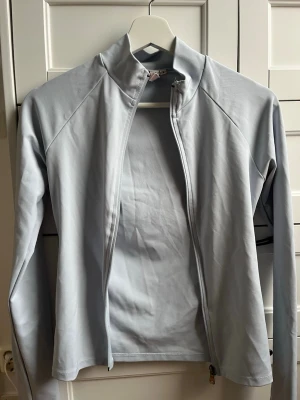 Ljusblå Zip tröja från Nelly - Använd en gång. Fint skick. Storlek S. Ljusblå, ser dock något grå ut i kameran. Pris kan diskuteras 