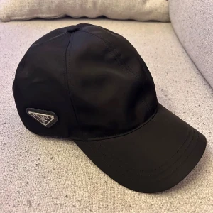 Keps från Prada  - Säljer en helt ny Prada keps, säljer pga att det inte är min stil och inget jag kommer att använda. Nypris: 4000-5500kr Mitt pris: 1899