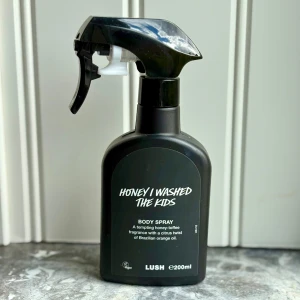 Honey I Washed The Kids Body Spray från Lush - En kroppsspray med söt doft av honung, kola och vanilj, toppad med friska toner av brasiliansk apelsin och bergamott. Perfekt för dig som gillar gourmanddofter med citrusinslag. 200 ml, enbart testad. 