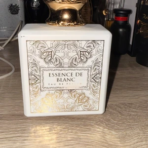 Essence De Blanc Eau de Parfum - Fräsch och modern parfym med noter av citron, apelsin, bergamott, neroli, kanel, ingefära, svart te, ambroxan, guaiacträ och olibanum. Tillverkad i U.A.E. Perfekt för dig som vill sticka ut med en unik doftprofil. Parfymen har suttit ganska länge hos mig så doften har utvecklats betydligt bättre. Flaskan är runt 80% fylld.
