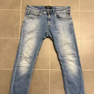 Replay ljusblå jeans, storlek 32 - Säljer ett par snygga ljusblå jeans från Replay i storlek 32. Jeansen har klassisk femficksdesign, smal passform och diskreta slitningar framtill. Materialet är mjukt jeans och midjan är normal. Perfekt för dig som gillar stilrena och bekväma jeans.