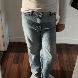 Ljusblå raka jeans - Säljer ett par ljusblå jeans med rak passform och klassisk femficksdesign. Jeansen har hög midja.