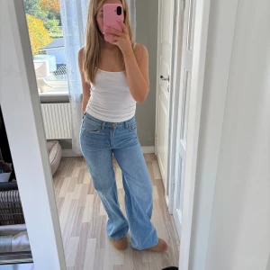 H&M ljusblå wide jeans - Säljer ett par ljusblå jeans från HM med klassisk femficksdesign och hög midja. Jeansen har en wide passform med raka, vida ben och är tillverkade i äkta denim. Perfekta för en avslappnad och trendig look.