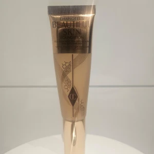 Charlotte Tilbury Beautiful Skin Foundation - Foundation från Charlotte Tilbury i en lyxig beige och guld tub med elegant design. Ger en naturlig och fräsch finish till huden. Perfekt för dig som vill ha en jämn och glowig bas. Tuben är smidig att ta med i väskan. Använd 2 gånger. Nyans 6n.