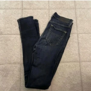 Mörkblå jeans - Snygga mörkblå skinny jeans med klassiska bakfickor och diskreta sömmar. Jeansen har en smal passform och är perfekta för dig som gillar en stilren look. Tillverkade i stretchigt jeansmaterial för extra komfort.