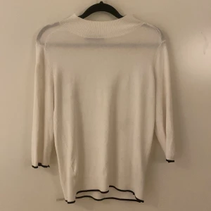 Vit polotröja från Zara med svarta detaljer - Snygg krämvit polotröja från Zara med svarta tunna tetaljer. 