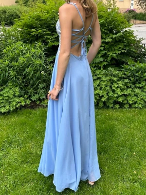 JJ’s house balklänning  - Jättefin balklänning från JJ’s House med spets och knuten rygg. Den har små paljetter insytt i spetsen. Jag på bilden är 171 lång och brukar ha stl S/xs. Hör av dig för frågor eller fler bilder🩷