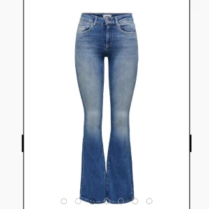 Blå bootcut jeans från ONLY - Snygga blå bootcut jeans från ONLY med medelhög midja och klassisk femficksdesign. Jeansen har en lätt tvättad look och är tillverkade i stretchigt denim för en bekväm passform. Perfekta att styla med sneakers eller boots. Kan skicka bättre bilder på färgen!