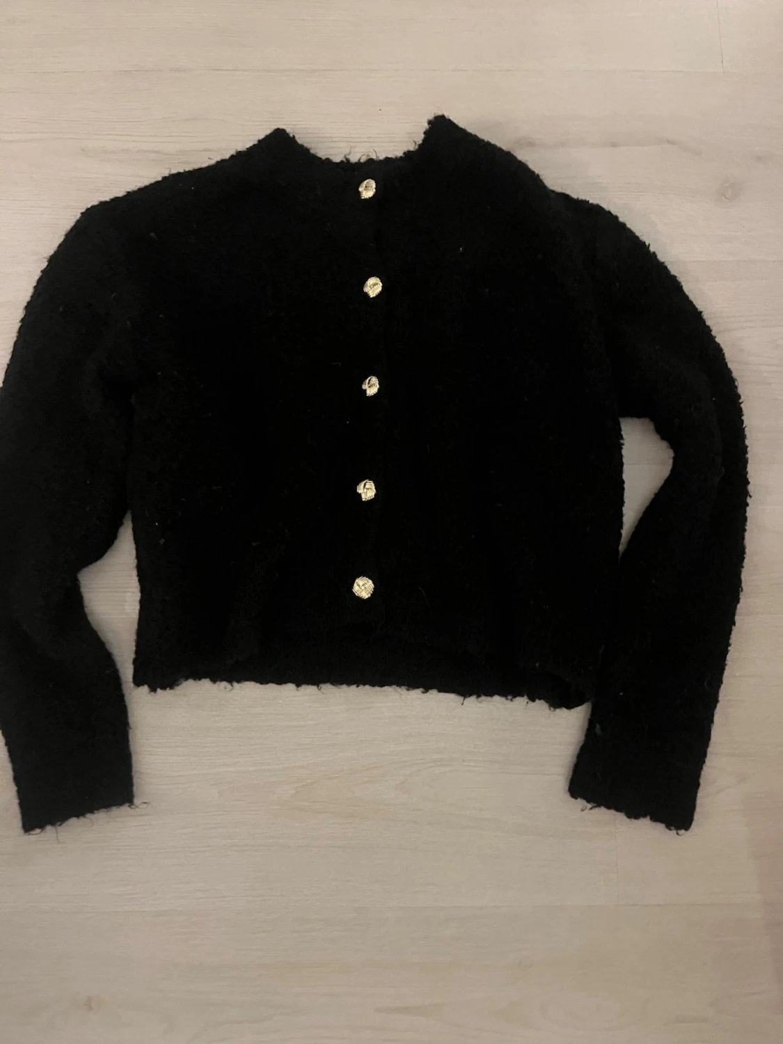Svart fluffig kofta med guldknappar