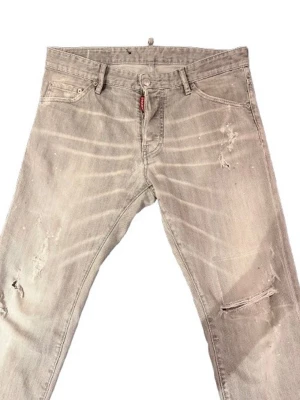 Dsquared jeans  - Säljer ett par grå dsquared2 jeans med slitningar och trasiga detaljer på benen. Jeansen är svin feta, och givetvis äkta 💪