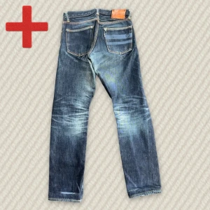 Momotaro GTB Selvedge  - A pair of Limited Edition Japanese Momotaro X Easy Navy Selvedge Jeans. Extremely rare. Size 28 on tag. Has minor flaws but is overall in good condition. See meassurements below!  Measurements: Waist – 39 cm, Rise – 25 cm, Thigh – 28 cm, Inseam – 78 cm, Length – 97 cm, Leg opening – 17 cm