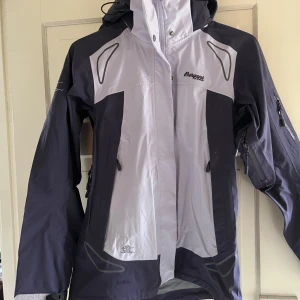 Bergans vindjacka  - Snygg Bergans Luster Lady vindjacka i storlek S. Jackan är tvåfärgad i ljusblått och mörkblått. Ej vattentät. 