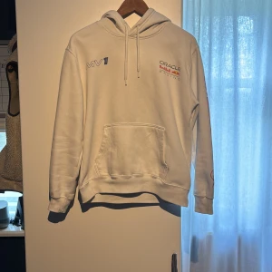 Vit Red Bull Racing hoodie Hollister XS - Vit hoodie från Hollister i samarbete med Red Bull Racing. Stor tryckt bil och nummer på ryggen, tryck på bröstet och ärmen. Klassisk hoodie, huva med snörning och mjukt material. 