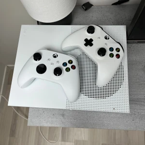 Xbox One S 1TB med två handkontroller och LED tangentbord med mus - Snygg Xbox One S 1TB i vitt, komplett med två original handkontroller. Konsolen och tillbehören är i fint skick utan synliga repor eller skador. Perfekt för gaming och streaming. Tangentbord och Razer-mus ingår för en komplett spelupplevelse. Snabb affär billigare pris