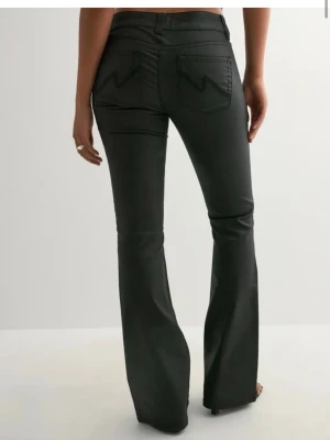 Populära ”läder”jeans - Snygga svarta bootcut jeans i läderimitation med markerade sömmar framtill och bakfickor med snygg detalj. Jeansen har låg midja och stängs med dubbla knappar. Perfekta för dig som vill ha en trendig och bekväm look. Andvända 1 gång och kostar 699kr nya! Storlek 40 men skulle mer säga 38