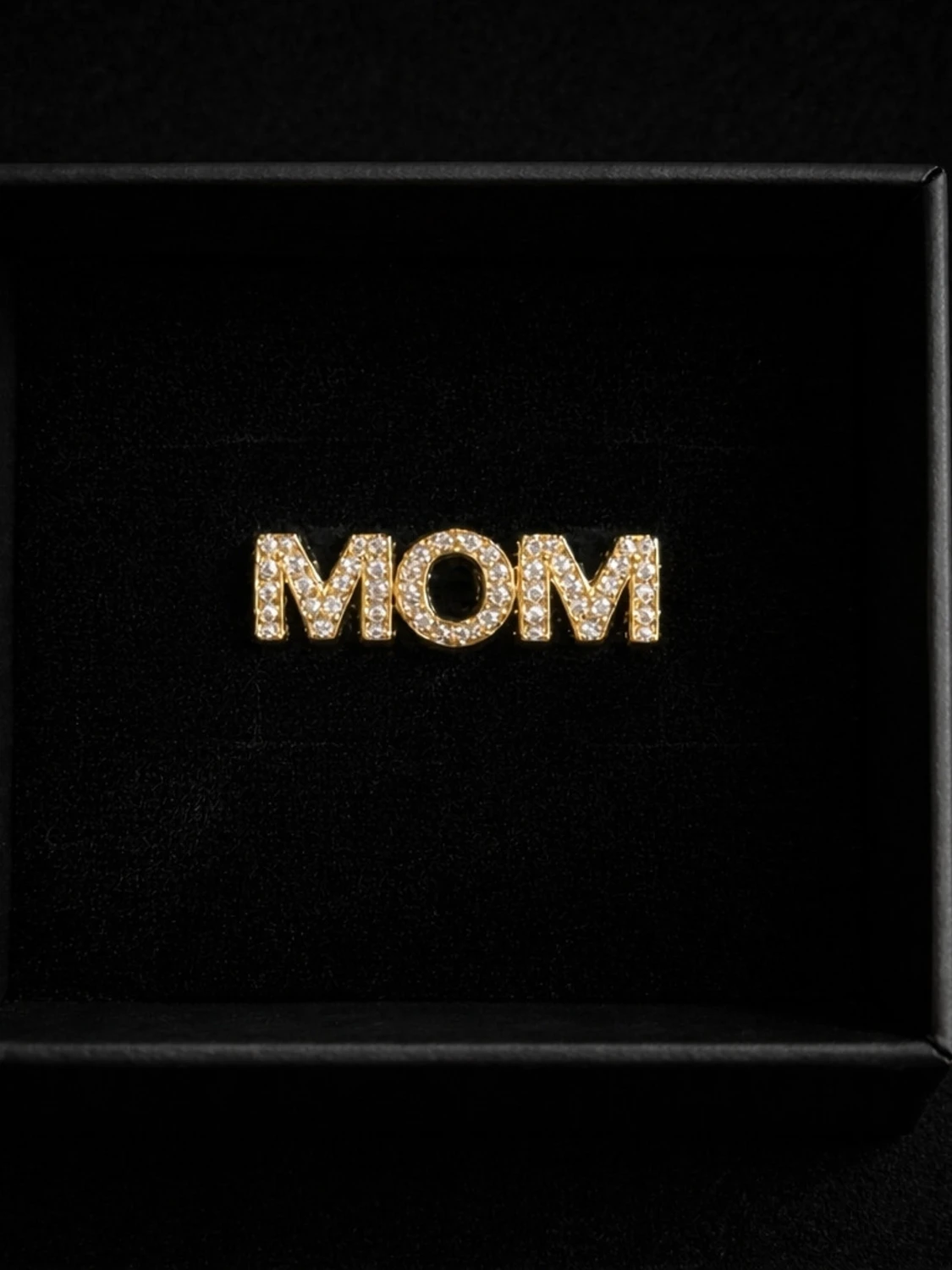 Guldfärgad ring med texten MOM