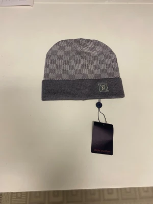 Lv beani - Item: Beanie / Hat Condition: New with tags Color: Grey Size: One size Gender: Unisex  Description: Grey knitted beanie. Soft and comfortable to wear, keeps your head warm. Simple everyday design with a folded cuff. Suitable for daily use.