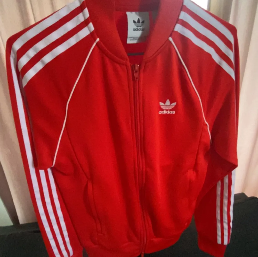 Röd adidas kofta . Storlek ” xs” Använt några gånger . Köpte för 599 .Väldigt skön material. Neuletakit & Villapaidat.