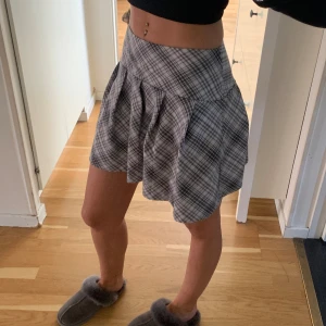 Coquette kjol - Super söt lågmidjad kjol perfekt till sommaren. Den är ”rutig” som man ser på bilderna. Skulle säga att det är gråvita färger. Passar xxs 🤍