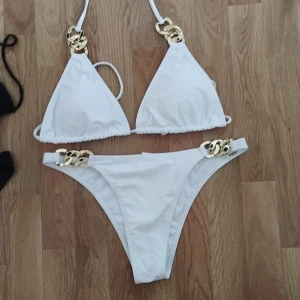 Bikini - Svart och vit bikini i storlek M-L, går att knyta runt nacken eller ryggen .  är aldrig använda