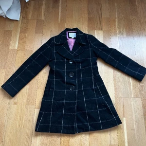 Svart kappa - Formats kappa med lätt vadderade axlar 