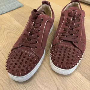 Selling my Christian Louboutin sneakers, in a very rare, cool and elegant burgundy suede with a white sole. Only used the shoes a few times so the condition is great. Replacement laces in white & a few spikes are included.  Please send your offers
