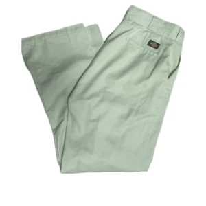 Dickies byxor - Mintgröna dickiesbyxor med deagkedja och knapp.