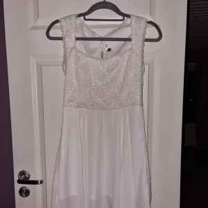 Klänning  - Vit klänning med överdel i spets från DM Retro. 