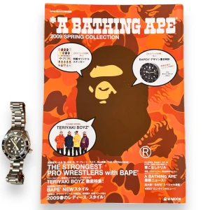 Bape Magasin 2009 - BAPE Magazine Book from 2009  72 pages of crazy lookbook collections showing products from the season, full sticker pack. Watchfor reference on how big the book is. Super cool accessory for anyone that loves Bape. These are a very interesting read!  