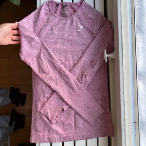 Gymshark tröja - Supersnygg tröja från Gymshark med hål för tummarna. Tyvärr är den stor för mig men den är i toppskick! 💘(färgen är såsom på den förtsa bilden men hade inte plat på fönsterkarmen för att ta med allt i bilden)