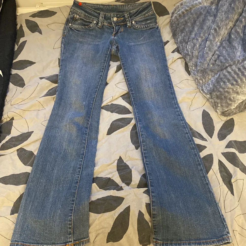 Super snygga bootcut Miss vivi jeans med vita kronor på fickorna. Inga defekter förutom en utbytt knapp. Midjemått: 34cm rakt över, innerbenslängd: 81cm. Jeans & Byxor.