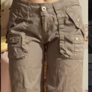 Cargo byxor low waist mid waist  - Säljer ett par skit snygga cargo byxor i mid/low waist! Det står strl M men passar även på xs/s men är lite stora där bak (se bild 3) för mig som bär xs-dock skulle det vara enkelt att lösa. Färgen är olivbrun💕💕  OBS!: skriv före du köper!! 