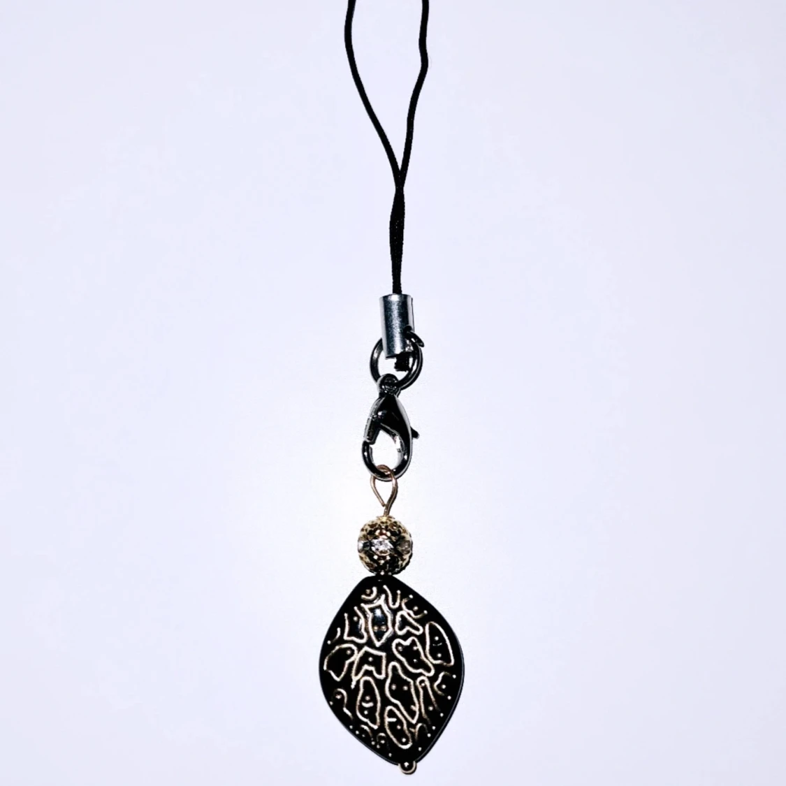 Svart accessoar till tex mobil/kläder