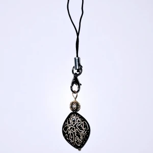 Svart accessoar till tex mobil/kläder - Svart akrylpärla med guldspringor, guldig metallpärla med glittrigt bling.