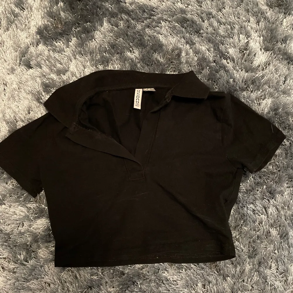 Fin svart tröja som är öppen där framme.  Säljs på grund av att den har blivit för liten😊. T-shirts.