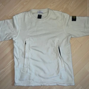 Stone island junior  - Sweater med mag dragkedja. Helt ny med prislapp endast testad. Nypris 2500kr. Strl 14 yr/164cm vilket är ungefär M. Färg Blandning av pistasch, gul och beige.